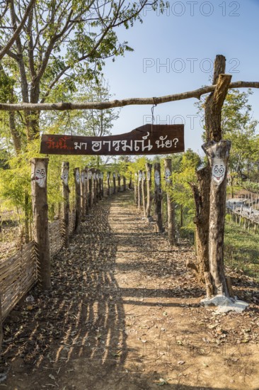 Walkway at the Akha Cottage coffee shop and restaurant in Chiang Rai Thiland asks What is your mood today? and has painted faces with differerent expressions of moods