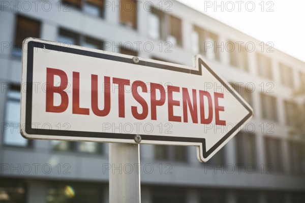 White arrow sign with German text Blutspende (Blood Donation) text in front of sunlit hospital. Clean visual emphasizes urgency and trust in blood donation, AI generated