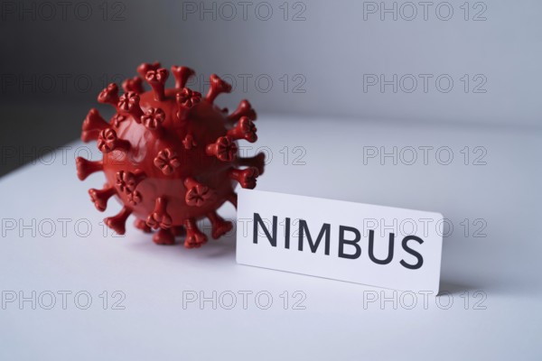 Red Corona virus model with Nimbus label on white surface. Generative Ai, AI generated