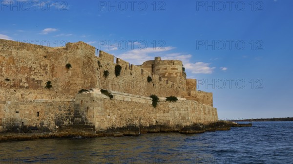 Castello Maniace, Sea Fortress Maniace, Mighty fortress along the coast, with robust architecture and blue sky, boat trip around the island of Ortigia, Isola di Ortigia, Syracuse, Sicily, Italy