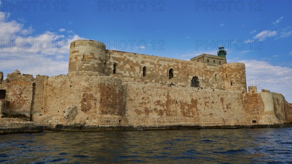 Castello Maniace, Maniace sea fortress, medieval castle with lighthouse by the sea under a blue sky, boat trip around the island of Ortigia, Isola di Ortigia, Syracuse, Sicily, Italy