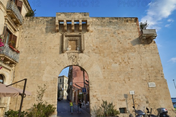 Historic stone city gate with visible road through the arch, Ortigia Island, Isola di Ortigia, Historic Old Town, Syracuse, Sicily, Italy