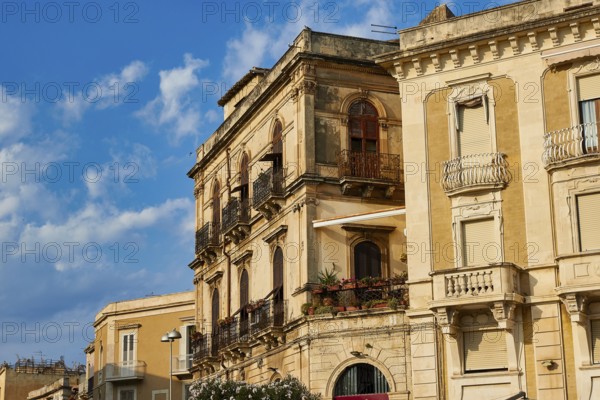 Close-up view of historic buildings with balconies and windows under blue sky, Ortigia Island, Isola di Ortigia, Historic Centre, Syracuse, Sicily, Italy