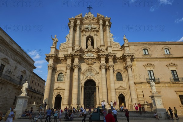 Cathedral of Syracuse, Magnificent baroque cathedral with imposing façade under blue sky, Groups of people on the square, Ortigia Island, Isola di Ortigia, Historic old town, Syracuse, Sicily, Italy