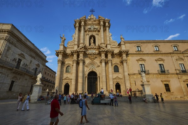 Cathedral of Syracuse, Large cathedral on a square with people and statues under a blue sky, Ortigia Island, Isola di Ortigia, Historic old town, Syracuse, Sicily, Italy