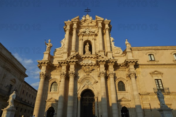 Cathedral of Syracuse, Magnificent facade of a cathedral in warm sunlight with detailed columns, Ortigia Island, Isola di Ortigia, Historic Old Town, Syracuse, Sicily, Italy