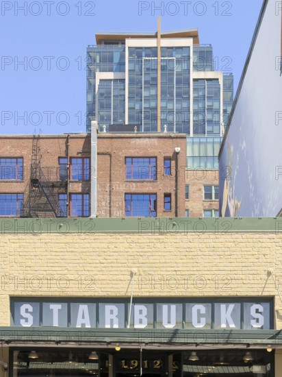 Starbucks sign on a wall of the oldest Starbucks from 1971 on Pike Place Market, Seattle, Washington, USA