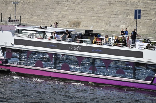 The media ship The Pionieer One sails on the Spree near the Kapelleufer