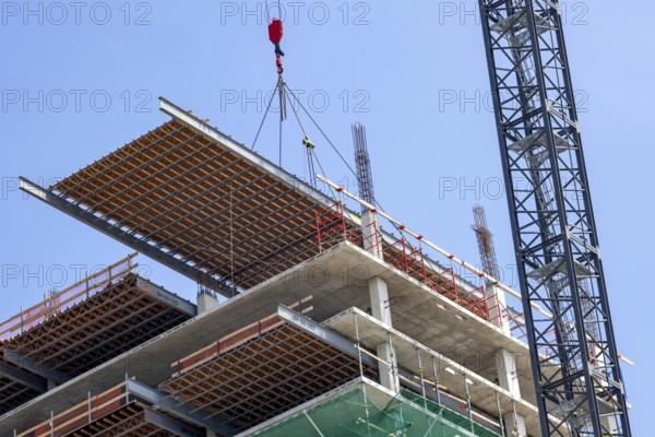Detroit, Michigan - Construction of the 25-story JW Marriott Detroit Water Square hotel. The framework for a new floor is lowered into place, cement will then be poured over it