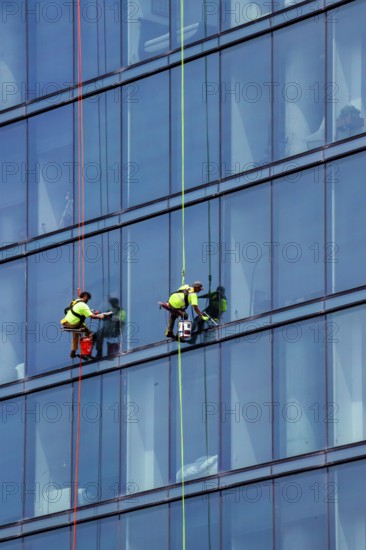 Detroit, Michigan - Window washers at the 25-story Residences Water Square luxury apartment building
