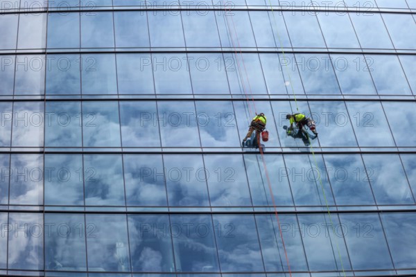 Detroit, Michigan - Window washers at the 25-story Residences Water Square luxury apartment building
