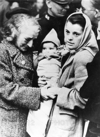 Soviet refugees, 1920, An older and a younger couple holding a baby wrapped in blankets in an emotional moment