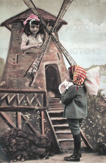 Children's windmill, miller, ca. 1910, Two children play a scene at a windmill in colourful costumes, historical photo