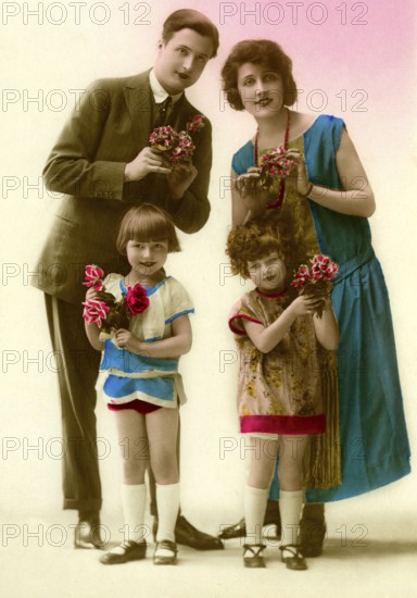 Family with flowers, 1930s, Family portrait with flowers in colourful clothes, smiling and posing, Historical photo