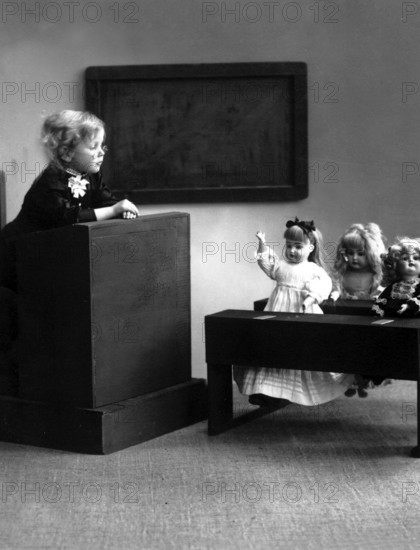 Doll school 1910, A child gives lessons for dolls in a miniature classroom, Historical photo