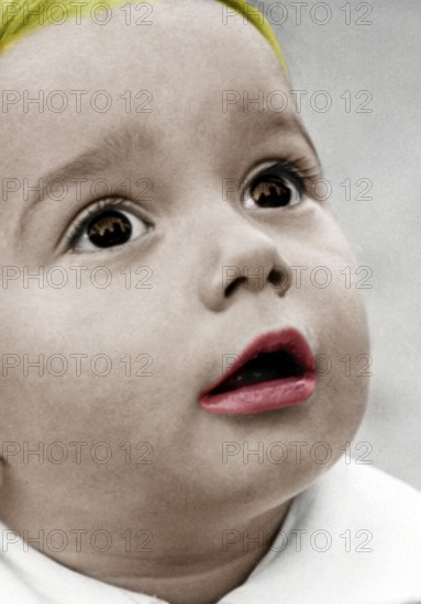 Little boy amazed, 1930s, close-up of a child with red coloured lips and astonished expression, historical photo