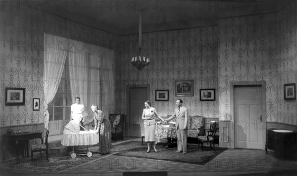Everyone watching baby in pram, 1930s, A family chatting in a living room next to a pram, Historical photo