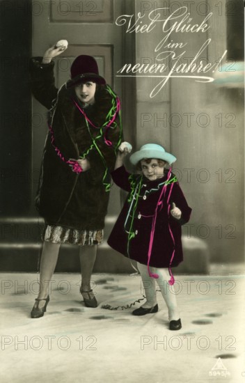 Good luck in the new year, 1930s, Two woman and a child throw snowballs and wish a happy new year, Historical photo