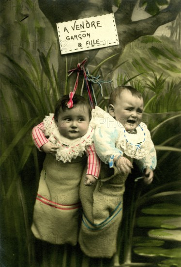 2 Babies in a sack, 1920, Two babies in sacks, hanging with a whimsical sign 'for sale', historical photo