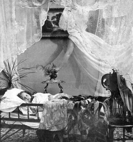 Guardian angel angel, 1910s, A child sleeps in bed while a ghostly veil hovers over him, Historical photo