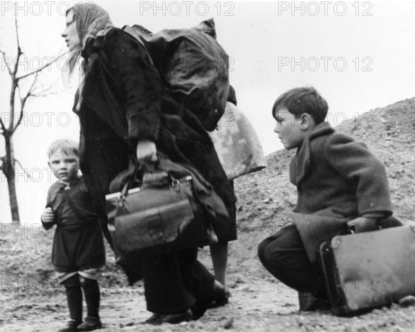 Mother and children with a lot of luggage, refugees displaced persons ca. 1946, A mother with two children and luggage on the way to an unknown future, Historical photo