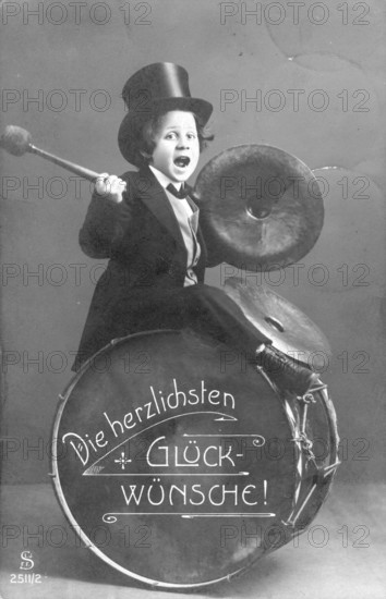 Child with a drum, 1920s, child in top hat plays drum and cymbal, labelled 'The warmest congratulations', historical photo