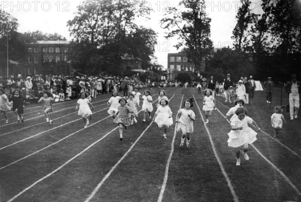 Many girls on race track, 1910, A group of children running on a race track in a friendly competitive environment, Historical photo