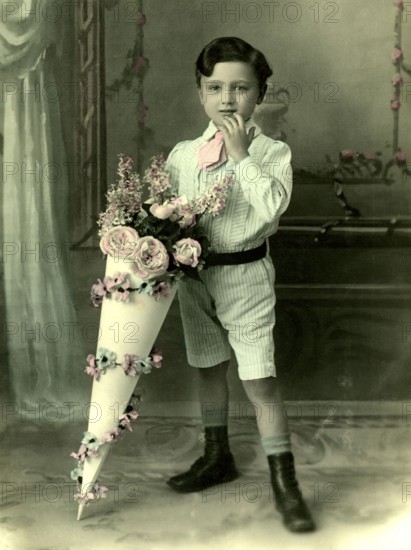 Boy with school cone, 1930s, A little boy in a suit with a large, decorative bouquet of flowers, Historical photo