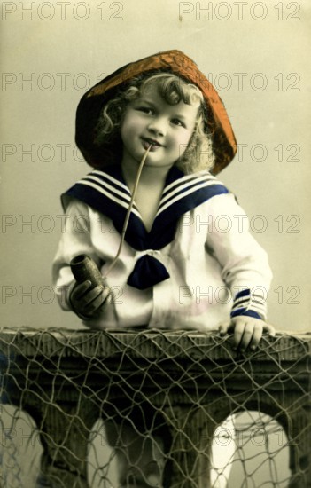 Girl in sailor look, 1920s, A boy in sailor clothes with pipe poses smiling, Historical photo