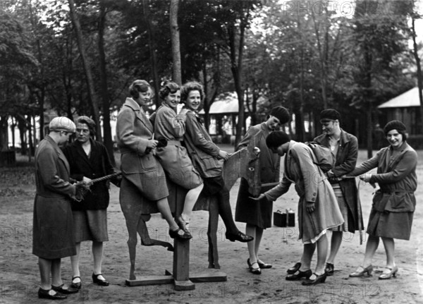 Group of woman, 1920s, A group of woman in a park enjoying time on a swing, Historical photo