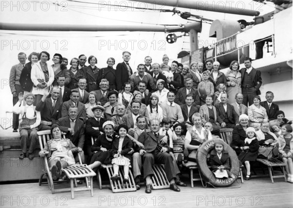 Group on ship deck, 1920s, Large group of people posing on a ship for a joint photo, Historical photo
