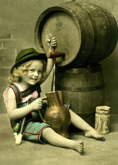 Girl tapping beer, 1920s, A girl in traditional clothing sits smiling next to a wooden barrel, Historical photo
