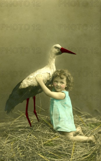 Girl with stork, 1910s, A child embraces a stork in a nest, surrounded by nature, Historical photo