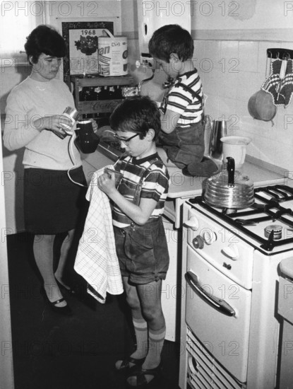 Mother and sons drying dishes, housework, education, 1960s, mother and two children busy in the kitchen doing housework, historical photo