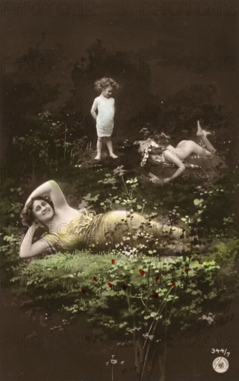 Woman and children posing in the forest, 1910s, Two woman and a child in a flowery meadow with a surreal touch, Historic photograph