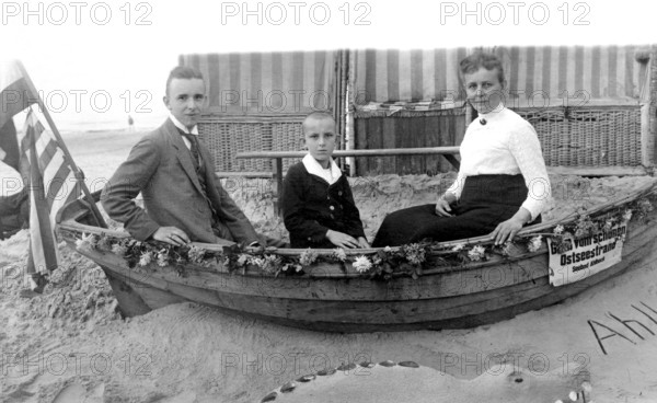 Family in a boat, beach, Baltic Sea, 1930s, Family sitting in a small boat on the beach, Historical photo