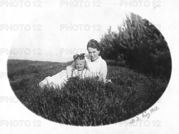 Mother and child, 1920s, Mother and daughter laughing in nature, Joy and relaxation, Black and white photo, Historical photo