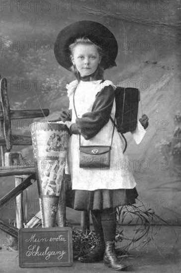 School enrolment, 1910s, girl with school bag and historical clothes, celebrating the start of school, historical photo
