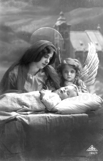 Angel with mother at the cot, 1920s, Angel and woman with halo watching over a sleeping child, historical photo