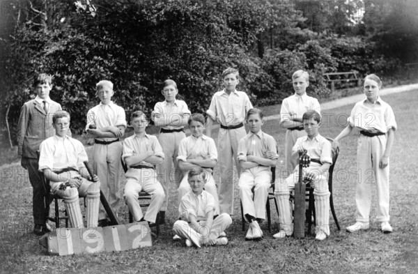 Cricket team, 1920s, Young cricket team members in uniform posing as a team outdoors, historical photo
