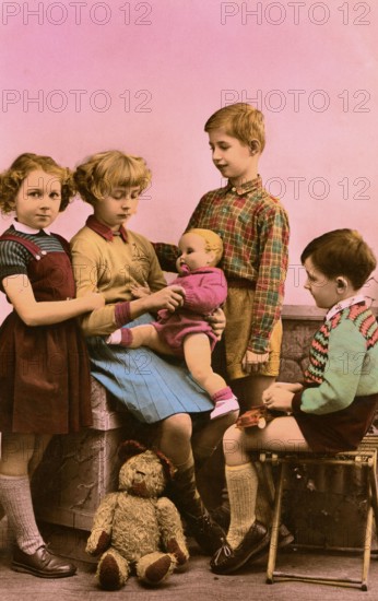 2 boys 2 girls, 1920s, Five children playing together with a doll in a nostalgic setting, Historical photo