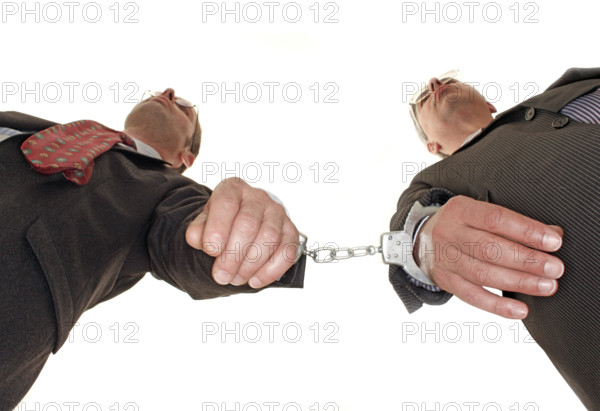 Businessman, two, handcuffs, suit and tie, Berlin, Germany, low angle shot of two men in handcuffs as if they were bound or trapped, historical photo