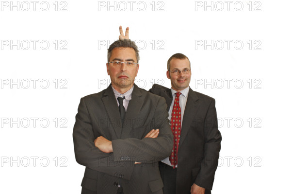 Businessman, two, suit and tie, Berlin, Germany, Two men in suits, the one in the back makes a humorous rabbit ears gesture behind the other, Historical photo
