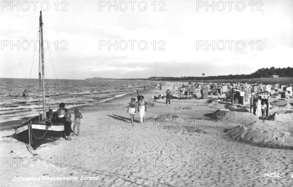 People on the beach, Baltic resort Trassenheide, 1930s, People walking and relaxing on the sunlit Baltic Sea beach, Historical photo