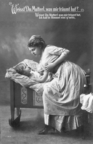 Mother with child, 1920s, A mother bends lovingly over her child in a beautiful cradle, Historical photo