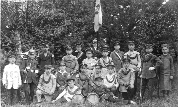 Children soldiers, 1920s, group of boys in uniform posing together outdoors, black and white, historical photo