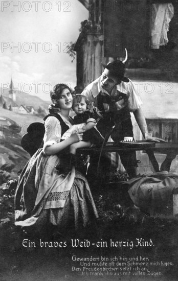 Young Bavarian family, 1920s, A family in traditional traditional costume on a terrace with an Alpine landscape in the background. A warm, harmonious scene, historical photo