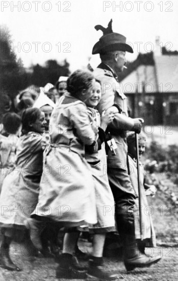 Kaiser Wilhelm with children, children laughing and playing around a uniformed man outdoors, historical photo