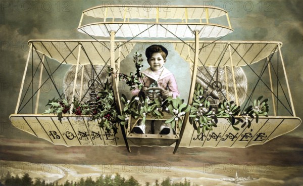 Child in aeroplane, 1920s, A child sits in a decorative old aeroplane, surrounded by plants, Historical photo