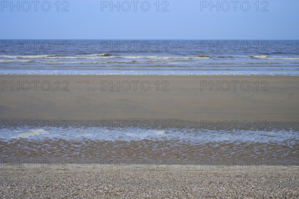 View of a wide sandy beach with gentle waves under a clear sky, beach section 27, Noordwijk, North Sea, Province of South Holland, Netherlands